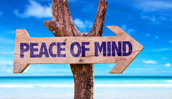 Wooden arrow sign that says "Peace of Mind"