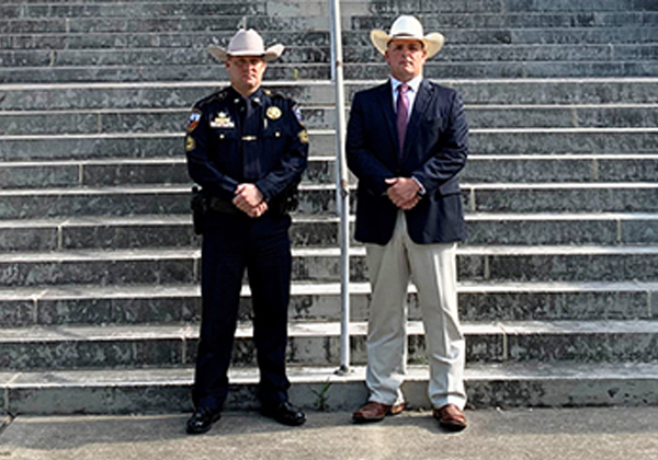Ector County Judge Dustin Fawcett standing with law enforcement officer on the front steps of the courthouse