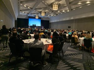 Boot camp attendees watching a presentation in a ballroom