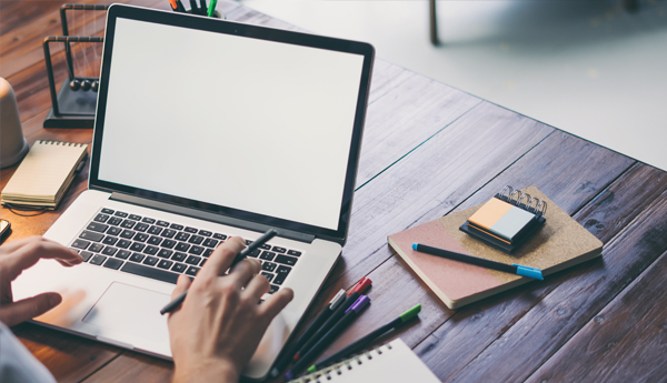 Graphic image of a person working on a laptop