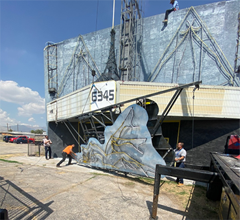 Construction crew removing a sign to replace it with a new one