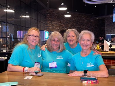 4 women smiling for a picture at boot camp social event