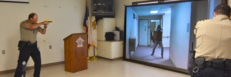 Peace and detention officers practicing aim with a simulator