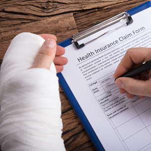 Person filling out a health insurance claim form