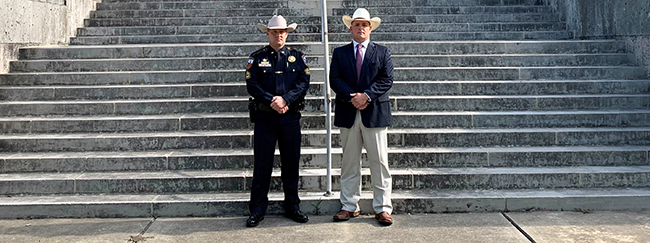 Ector County Judge Dustin Fawcett standing with law enforcement officer on the front steps of the courthouse